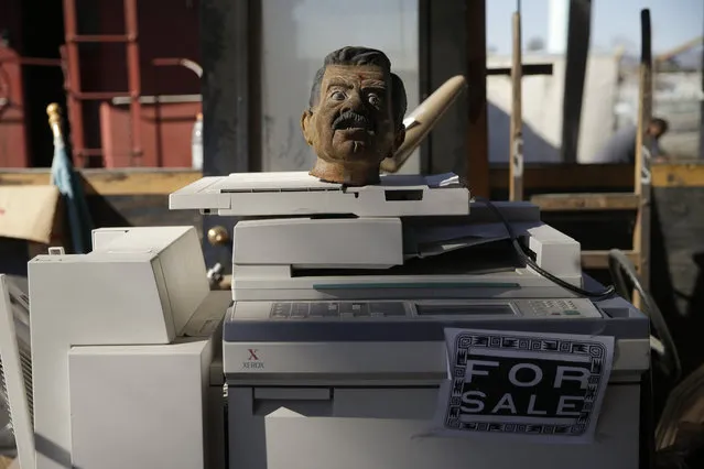 In this Wednesday, November 11, 2015 photo, a bust sits on a copy machine at Aadlen Brothers Auto Wrecking, also known as U Pick Parts, in the Sun Valley section of Los Angeles. (Photo by Jae C. Hong/AP Photo)