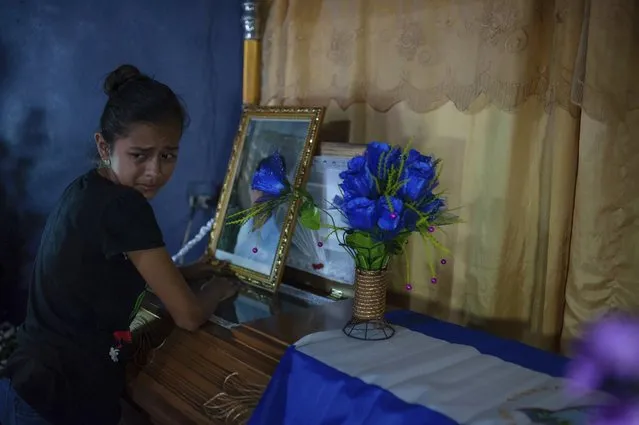 A woman cries next to coffin of Leyling Chavarria, after he was killed when police and paramilitaries attacked a barricade at the Sandino neighborhood of Jinotega, Nicaragua, Tuesday, July 24, 2018. Four more people have been killed in Nicaragua amid unrest that has rocked the country for over three months. (Photo by Cristobal Venegas/AP Photo)