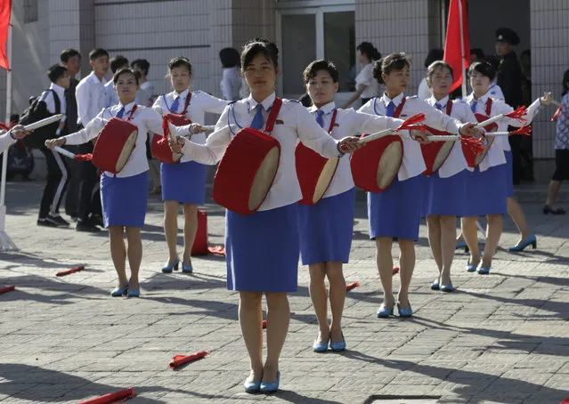 North Korean women play drums to encourage workers to start their day off with more vigor during morning rush hour in Pyongyang, North Korea, Friday, June 22, 2018. (Photo by Dita Alangkara/AP Photo)