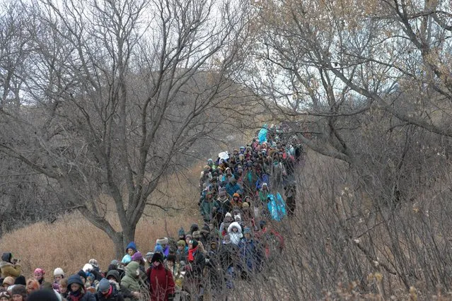 People march in Oceti Sakowin camp during a protest against plans to pass the Dakota Access pipeline near the Standing Rock Indian Reservation, near Cannon Ball, North Dakota, U.S. November 27, 2016. (Photo by Stephanie Keith/Reuters)