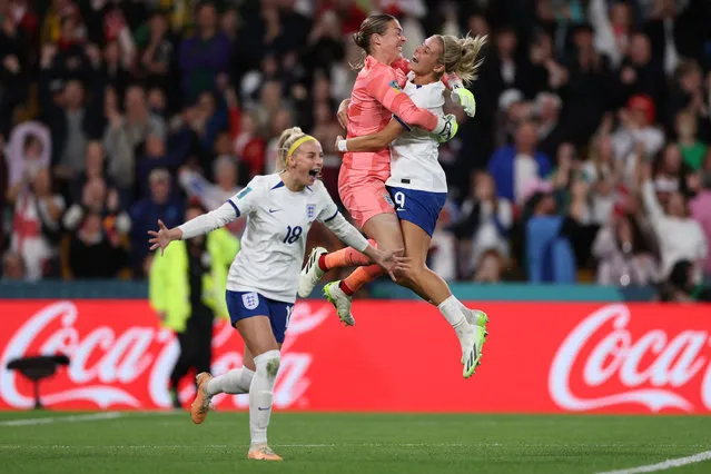 Chloe Kelly (pictured left) celebrates with Rachel Daly and Mary Earps after scoring England’s fifth and winning penalty in a shootout during the Fifa Women’s World Cup round of 16 match against Nigeria in Brisbane, Australia on August 7, 2023. (Photo by Elsa/FIFA/Getty Images)