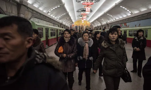 Commuters walk through a subway station in Pyongyang on November 28, 2016. (Photo by Ed Jones/AFP Photo)