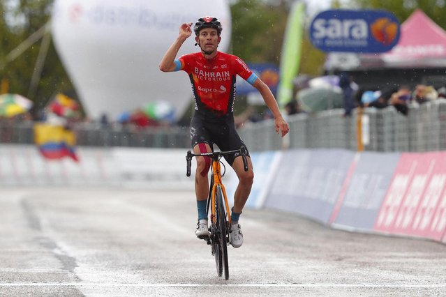 Team Bahrain rider Switzerland's Gino Mader celebrates as he crosses the finish line to win during the sixth stage of the Giro d'Italia 2021 cycling race, 160 km between Grotte di Frasassi and Ascoli Piceno (San Giacomo) on May 13, 2021. (Photo by Luca Bettini/AFP Photo)