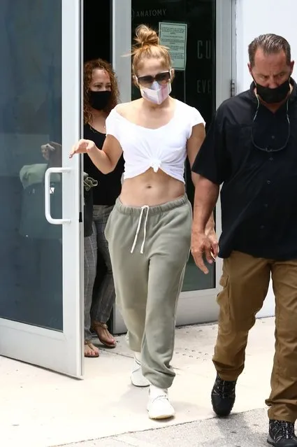 J-Lo's post-break up body is remaining flawless! The superstar left a gym session in Miami on May 12, 2021 with a shirt so sweaty she had to twist it into a knot. Jenny revealed an incredibly toned waist as she returned to her ride. (Photo by Backgrid USA)
