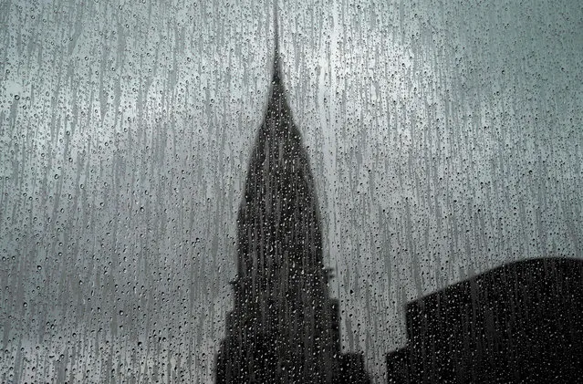 The Chrysler Building is seen through a rain covered high- rise window on August 13, 2018. The Chrysler Building is an Art Deco–style skyscraper located on the East Side of Midtown Manhattan in New York City and one of the city landmarks. (Photo by Timothy A. Clary/AFP Photo)