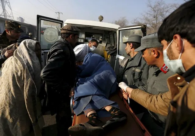 Police and relatives load an injured Afghan woman into an ambulance after she was wounded by a suicide attack in Kabul, Afghanistan, December 28, 2015. (Photo by Mohammad Ismail/Reuters)