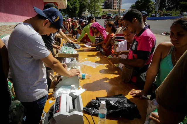 People buy goods from a food wholesaler in Ciudad Bolivar, Venezuela December 19, 2016. (Photo by William Urdaneta/Reuters)