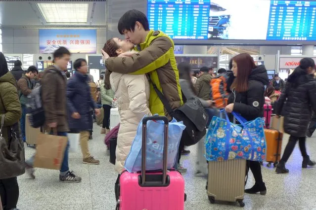 A couple kisses at Shanghai Hongqiao Railway Station ahead of the upcoming Chinese Lunar New Year, China, February 5, 2016. (Photo by Reuters/Stringer)
