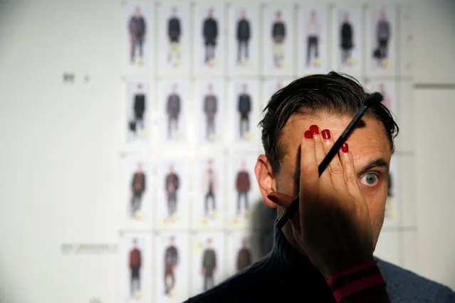A model is groomed backstage of the Oliver Spencer catwalk show during London Fashion Week Men's 2017 in London, Britain January 7, 2017. (Photo by Neil Hall/Reuters)