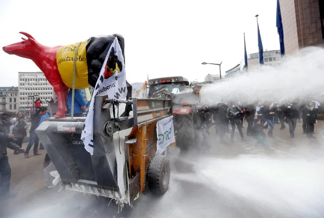 Milk producers spray powdered milk to protest against dairy market overcapacity outside a meeting of European Union agriculture ministers in Brussels, Belgium, January 23, 2017. (Photo by Francois Lenoir/Reuters)