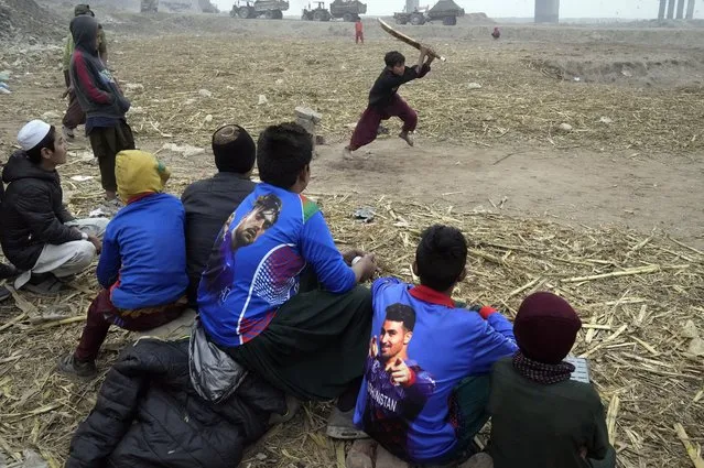 Boys play Cricket on the outskirts of Lahore, Pakistan, Sunday, December 31, 2023. (Photo by K.M. Chaudary/AP Photo)