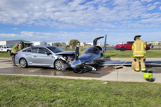This photo provided by the McKinney Fire Department shows officials at the site of a crash involving a small plane and a vehicle near Aero Country Airport, Saturday, November 11, 2023, in McKinney, Texas. Authorities say a small plane overshot the runway while trying to land at a Texas airport and struck a car that was driving along a nearby road, injuring one person. (Photo by McKinney Fire Department via AP Photo)