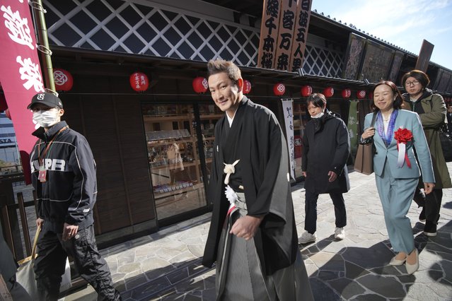Japanese actor Shido Nakamura walks on the street after the opening ceremony of “Toyosu Senkyaku Banrai”, an Edo Period-themed hot spring complex at Toyosu Fish Market Thursday, February 1, 2024, in Tokyo. Japan's biggest fish market on Thursday opened a long-awaited outer section with Japanese-style seafood restaurants and a spa for relaxation, as the wholesale venue that has struggled since relocating from the beloved Tsukiji market seeks to lure more visitors. (Photo by Eugene Hoshiko/AP Photo)