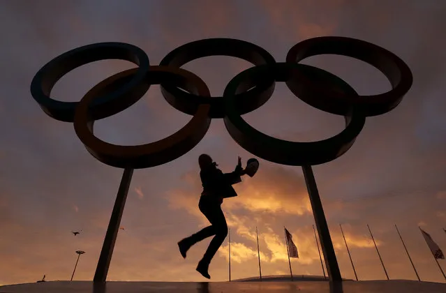 A woman poses for with the Olympic rings in Olympic Park as preparations continue for the 2014 Winter Olympics, Wednesday, Feb. 5, 2014, in Sochi, Russia. (Photo by Charlie Riedel/AP Photo)