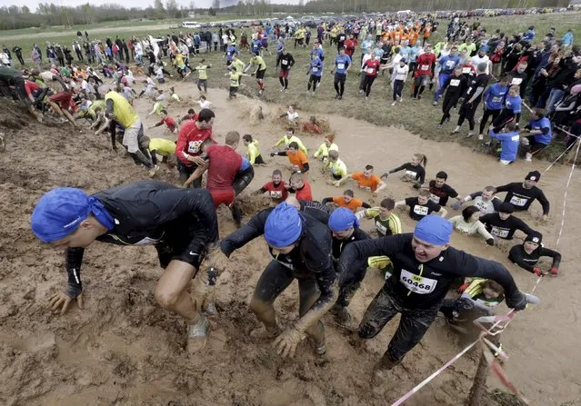 Participants compete during the Strong Race event near Tukums, Latvia, May 3, 2015. (Photo by Ints Kalnins/Reuters)