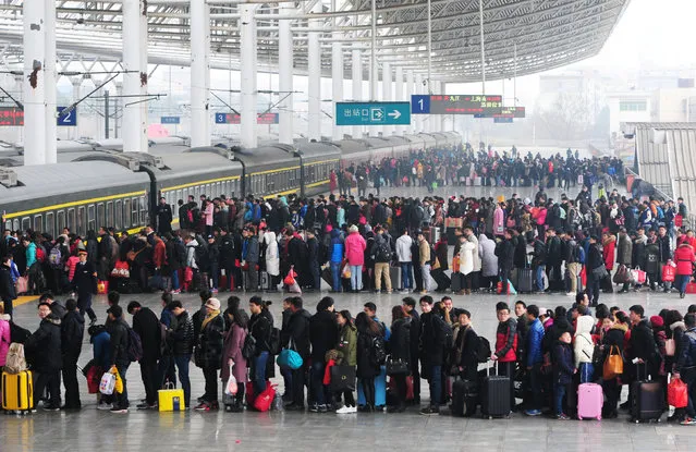 People wait to board a train on the last day of Chinese Lunar New Year holidays at a railway station in Jiujiang, Jiangxi province, China, February 2, 2017. (Photo by Reuters/Stringer)