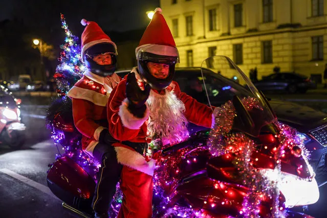 Motorcycle fans dressed as Santa Claus ride near Charlottenburg Palace (Schloss Charlottenburg)during the 25th annual “Santa Claus On Road” Berlin Bike Tour, to deliver gifts to the needy on December 10, 2022 in Berlin, Germany. Some 200 riders with vehicles decorated with lights and mini-Christmas trees took part in the annual event on its 25 year. Anyone may ride along, whether on motorcycle, trike or quad, as long as the vehicle is decorated accordingly. (Photo by Omer Messinger/Getty Images)