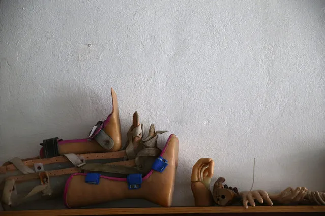 Prosthesis are seen at a welfare workshop in the Duma neighborhood in Damascus October 24, 2013. The center produces prosthesis from different materials including remnants of weapons, plastic mannequins and water barrels, and offer them to physically disabled victims of the war. (Photo by Bassam Khabieh/Reuters)