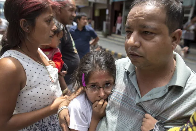 Local residents evacuate onto a street minutes after an earthquake in central Kathmandu, Nepal, May 12, 2015. (Photo by Athit Perawongmetha/Reuters)