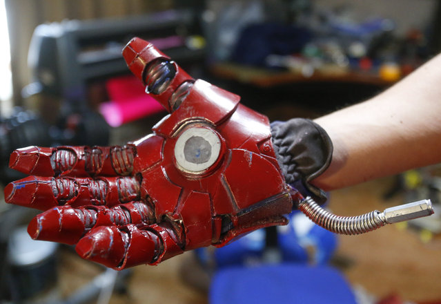 In this photo taken April 8, 2015, Clay Hielscher of Overbrook, Kan., shows the hand of his Iron Man suit that he constructed using a work glove, foam, and a LED flashlight that he rewired to stereo connectors. (Photo by Chris Neal/AP Photo/The Topeka Capital-Journal)