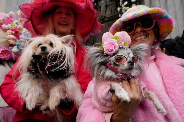 Leslie and her dog Puccini and Joanna and her dog Chichi Love take part in the annual Easter Parade and Bonnet Festival on 5th Avenue outside St. Patrick's Cathedral in Manhattan in New York City, U.S., March 31, 2024. (Photo by Adam Gray/Reuters)