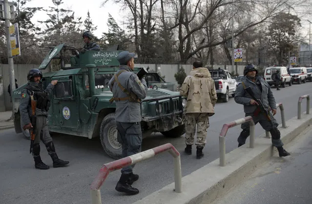 Security forces block the main road of the biggest military hospital after the clash started between insurgent fighters and army soldiers at the gate of the hospital, in Kabul, Afghanistan, Wednesday, March 8, 2017. Gunmen stormed a military hospital Wednesday in a neighborhood in the Afghan capital that is also home to a number of embassies. (Photo by Massoud Hossaini/AP Photos)