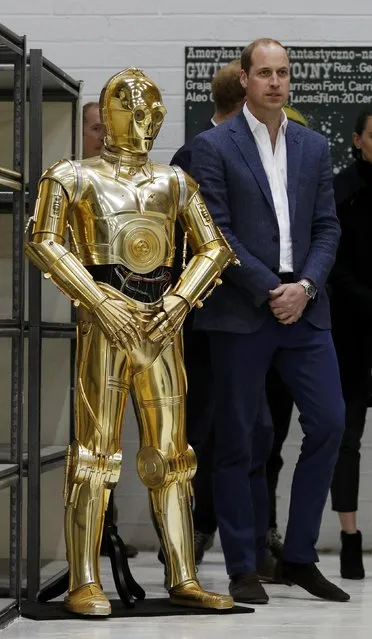 Britain Prince William looks at droid C3P0 from Star Wars as they visit the creature and droid department at Pinewood studios in Iver Heath, west of London, Britain on April 19, 2016. (Photo by Adrian Dennis/Reuters)