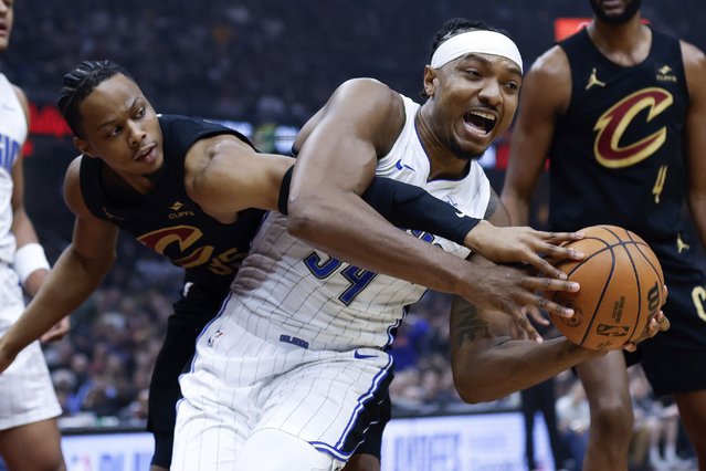 Orlando Magic center Wendell Carter Jr. (34) controls a rebound against Cleveland Cavaliers forward Isaac Okoro during the first half of Game 5 of an NBA basketball first-round playoff series, Tuesday, April 30, 2024, in Cleveland. (Photo by Ron Schwane/AP Photo)