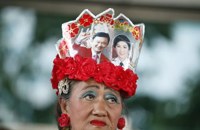 A supporter of Thai former Prime Minister Yingluck Shinawatra wears a headband decorated with pictures of Yingluck Shinawatra (R) and her brother fugitive former Prime Minister Thaksin Shinawatra (L) outside the Supreme Court's Criminal Division for Holders of Political Positions, in Bangkok, Thailand, 22 April 2016. Yingluck Shinawatra is on trial for criminal charges stemming from her government's rice price subsidy. The rice subsidy plan was a key promise during Yingluck Shinawatra's Pheu Thai party's 2011 electoral campaign. (Photo by Narong Sangnak/EPA)