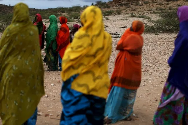 Women look on as men show aid workers the carcasses of livestock that died due to drought close to the town of Borama, Somaliland April 17, 2016. (Photo by Siegfried Modola/Reuters)