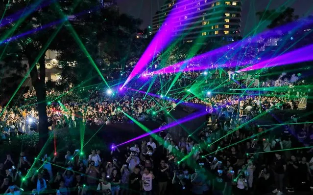 Protesters use laser pointers during a rally to demonstrate against the arrests of people caught in possession of laser pointers that police classified as offensive weapons because of their ability to harm the eyes in Hong Kong, Wednesday, August 7, 2019. Hong Kong is facing its “most severe situation” since its handover from British rule in 1997 following weeks of demonstrations and the central government is considering what measures to take next, the head of Beijing's Cabinet office responsible for the territory said Wednesday. (Photo by Kin Cheung/AP Photo)