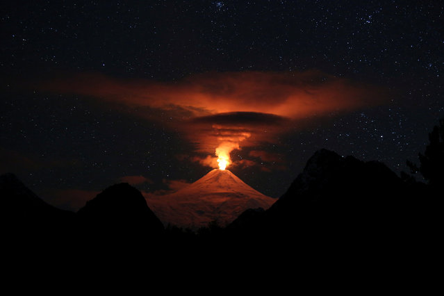 A view shows activity of the Villarrica volcano during the night, as seen from Pucon, Chile on May 12, 2024. (Photo by Cristobal Saavedra Escobar/Reuters)