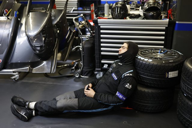 A mechanic sleeps in the paddock during the 24 Hours of Le Mans sports-car race Sunday, June 16, 2024, in Le Mans, France. (Photo by Jeremias Gonzalez/AP Photo)