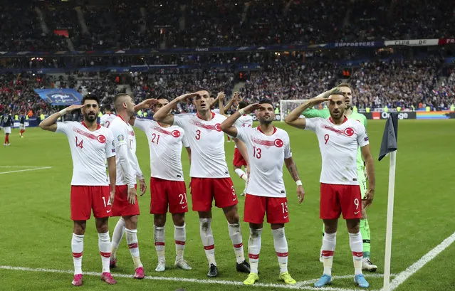 Turkey's players salute as they celebrate a goal against France during the Euro 2020 group H qualifying soccer match between France and Turkey at Stade de France at Saint Denis, north of Paris, France, Monday, October 14, 2019. (Photo by Thibault Camus/AP Photo)