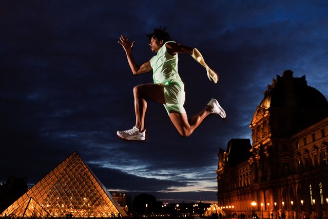 France's paralympic triple jumper Arnaud Assoumani poses in front of The Louvre Pyramide, designed by Ieoh Ming Pei, in Paris on April 20, 2024, ahead of the Paris 2024 Olympic and Paralympic games. The Louvre was originally built as a fortress in the late 12th century, became one of the main residences of the kings of France later and actually is one of the largest museum in the world. (Photo by Franck Fife/AFP Photo)