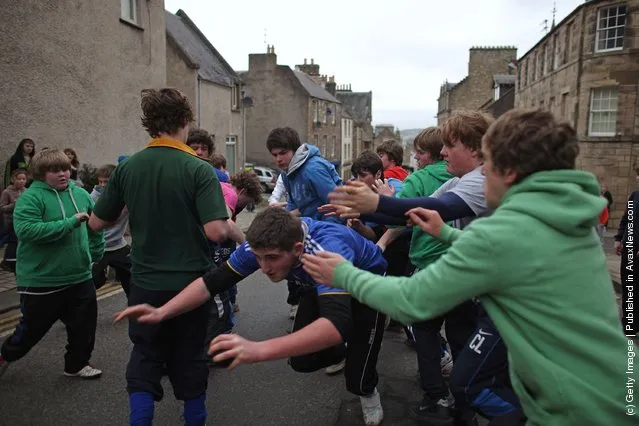 Youths tussle for the leather ball during the annual 'Fastern Eve Handba' event in Jedburgh's High Street in the Scottish Borders in Jedburgh