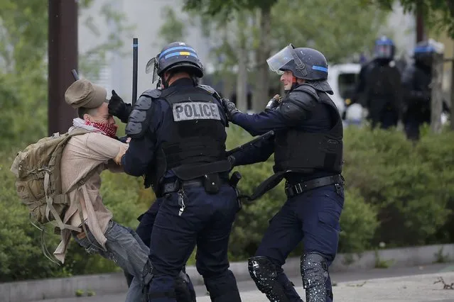 French police apprehend a youth during a demonstration to protest the government's proposed labour law reforms in Nantes, France, May 26, 2016. (Photo by Stephane Mahe/Reuters)