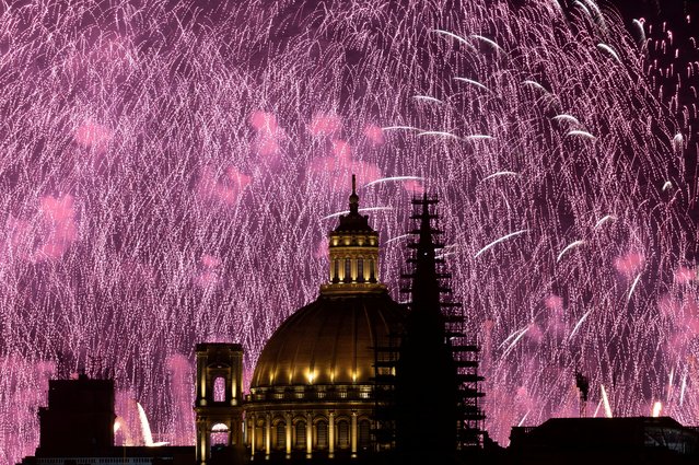 Fireworks explode behind the steeple of St Paul's Anglican Pro-Cathedral and the dome of the Basilica of Our Lady of Mount Carmel during the Malta International Fireworks Festival in Valletta, Malta on April 30, 2023. (Photo by Darrin Zammit Lupi/Reuters)