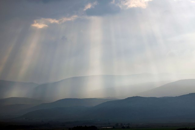 Sunlight breaks through the clouds on the hills of Ramim Ridge in Upper Galilee in northern Israel near the Lebanon border on January 2, 2024, amid ongoing cross-border tensions as fighting continues between Israel and Hamas militants in Gaza. (Photo by Jalaa Marey/AFP Photo)