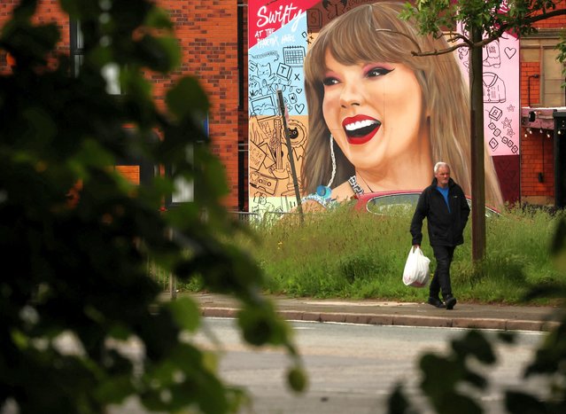 A man walks past a mural by Murwalls of U.S. musician Taylor Swift outside the Phoenix Hotel, ahead of the star’s Eras tour which arrives in the city for 3 nights next month, in Liverpool, Britain, on May 30, 2024. (Photo by Phil Noble/Reuters)