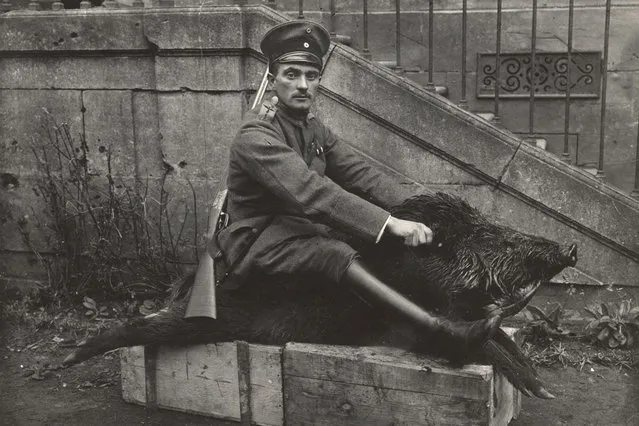 A German Air Force Officer sits astride a dead boar outside a house where he is stationed near the Western Front, in this 1918 handout picture. This picture is part of a previously unpublished set of World War One (WWI) images from a private collection. The pictures offer an unusual view of varied and contrasting aspects of the conflict, from high tech artillery to mobile pigeon lofts, and from officers partying in their headquarters to the grim reality of life and death in the trenches. The year 2014 marks the centenary of the start of the war. (Photo by Reuters/Archive of Modern Conflict London)