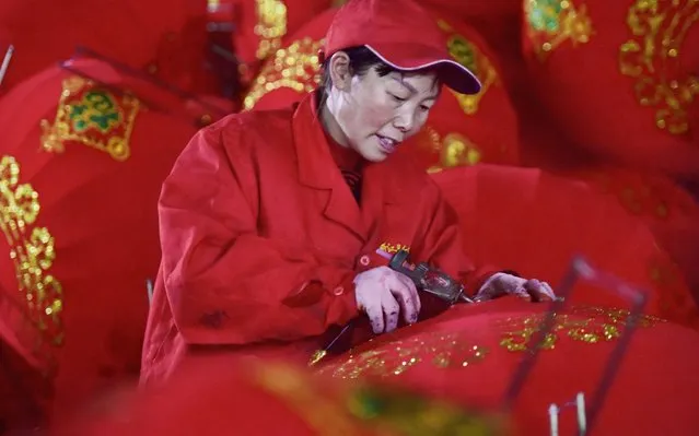 A worker makes red lanterns ahead of upcoming Lunar New Year celebrations on January 25, 2020, at a factory in Wuyi in China's eastern Zhejiang province on December 26, 2019. (Photo by AFP Photo/China Stringer Network)