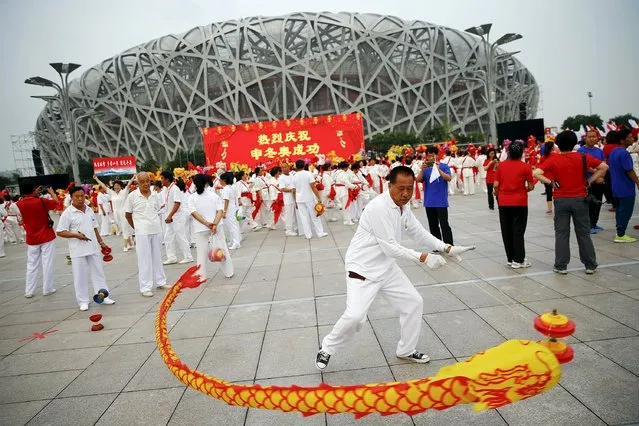 People celebrate after Beijing was chosen to host the 2022 Winter Olympics at the Bird's Nest Olympic stadium in Beijing July 31, 2015. (Photo by Damir Sagolj/Reuters)