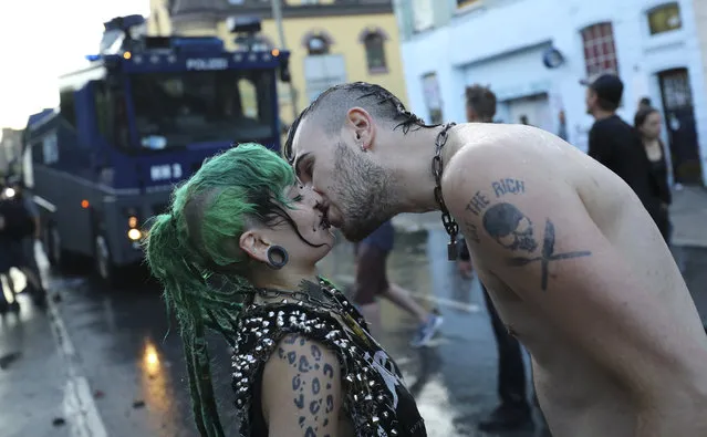 A couple kisses each other in front of a water cannon during clashes between German police and anti-G20 protesters in Hamburg, Germany on Thursday, July 6, 2017. (Photo by Kai Pfaffenbach/Reuters)