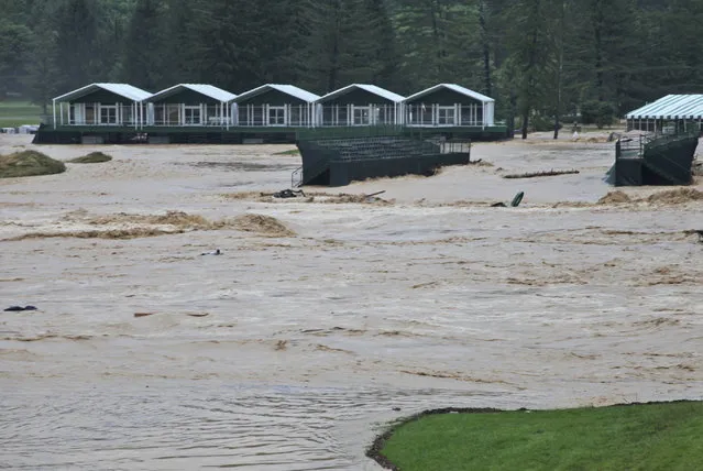 This Thursday June 23, 2016 image provided by the Greenbrier shows flooding on the 17th green of the Old White Course at the Greenbrier in White Sulphur Springs, W. Va. Severe flooding hit the area that is scheduled to host a PGA tour event in two weeks. (Photo by Cam Huffman/The Greenbrier via AP Photo)