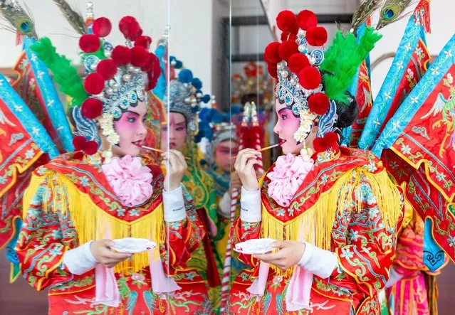 Children learn Peking Opera makeup at a Peking Opera club in Haian, East China's Jiangsu Province on June 10, 2022. (Photo by CFOTO/Sipa USA/Alamy Live News)