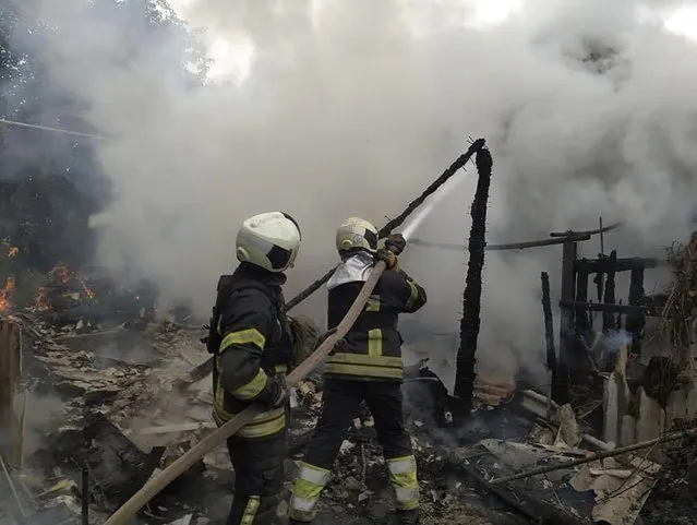 In this photo provided by the Luhansk region military administration, Ukrainian firefighters work to extinguish a fire at damaged residential building in Lysychansk, Luhansk region, Ukraine, early Sunday, July 3, 2022. Russian forces pounded the city of Lysychansk and its surroundings in an all-out attempt to seize the last stronghold of resistance in eastern Ukraine's Luhansk province, the governor said Saturday. A presidential adviser said its fate would be decided within the next two days. (Photo by Luhansk region military administration via AP Photo)