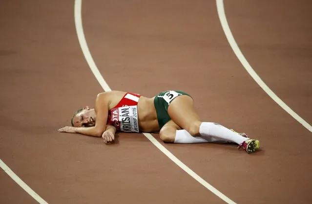 Xenia Krizsan of Hungary lies on the floor after competing in the 800 metres heats of the women's heptathlon during the 15th IAAF World Championships at the National Stadium in Beijing, China August 23, 2015. (Photo by David Gray/Reuters)