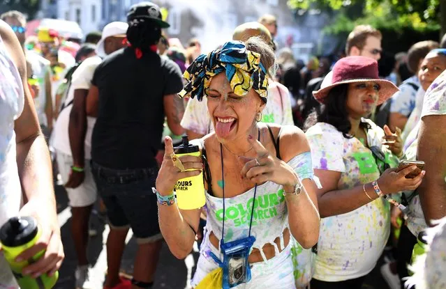 Revellers walk through Notting Hill Carnival on August 27, 2017 in London, England. The Notting Hill Carnival began with a special ceremony of remembrance following the Grenfell fire tragedy. (Photo by Leon Neal/Getty Images)
