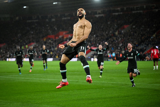 Liverpool's Egyptian striker #11 Mohamed Salah (C) celebrates after shooting a penalty kick and scoring his team third goal during the English Premier League football match between Southampton and Liverpool at St Mary's Stadium in Southampton, southern England on November 24, 2024. (Photo by Justin Tallis/AFP Photo)